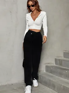 Model wearing black high-waisted wide-leg denim pants and a white cropped zip hoodie