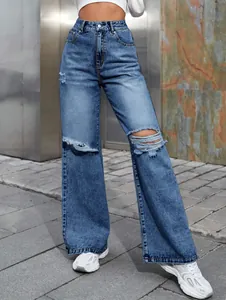 Gros plan d'un jean à taille haute et jambe large avec des déchirures aux genoux