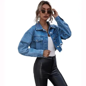 Stylish women's oversized cropped denim jacket in light blue wash featuring a raw frayed hem
