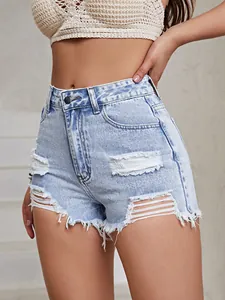 Close-up view of light blue high-waisted denim shorts with distressed holes and frayed hem