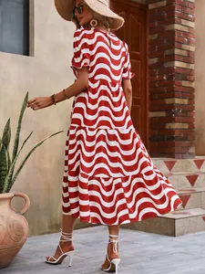 Back view of a red and white wavy print midi dress with puff sleeves and tiered skirt