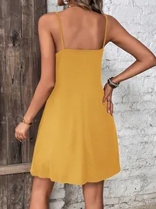 Back view detail of casual yellow sleeveless spaghetti strap mini dress for women.