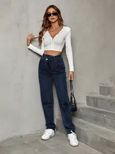 High-waisted loose denim jeans with asymmetrical waist styled with a white crop hoodie