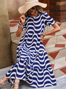 Detailed outdoor view of blue and white wave print tiered dress with puff sleeves