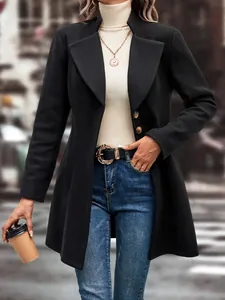 Detailed view of women's black lapel wool coat styled with a turtleneck and jeans