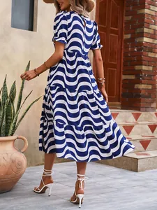 Blue and white wave print tiered midi dress with puff sleeves shown from the rear view