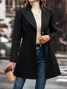 Detailed view of a black wool lapel coat styled with denim for autumn and winter fashion.