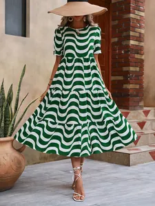 Detailed view of green and white wavy print tiered midi dress with puff sleeves