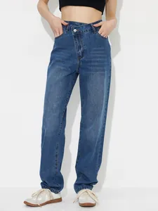 High-waisted loose denim pants with a unique asymmetric cross-over waist detail.