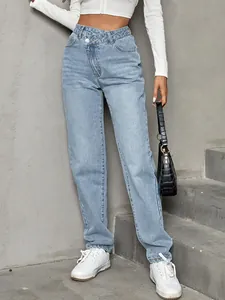 Detail of light blue high-waisted denim jeans with asymmetric button fly design.