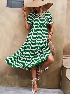 Detail view of a green and white wavy print puff sleeve tiered dress for summer