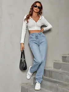 Close-up of high waist loose fitting blue denim jeans with asymmetric waist detail