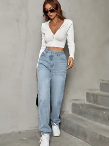 Stylish high-waisted loose denim jeans paired with white cropped hoodie