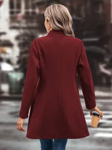 Back view of stylish burgundy solid color wool coat for women in an urban street setting