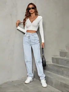 Fashionable high-waisted loose light blue jeans with unique crossover waist design