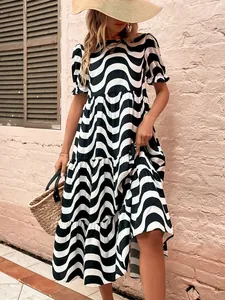 Detail view of a black and white wavy print dress with puff sleeves and loose fit