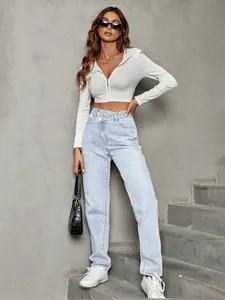Full length view of light blue high waisted jeans with unique asymmetric crossover waist