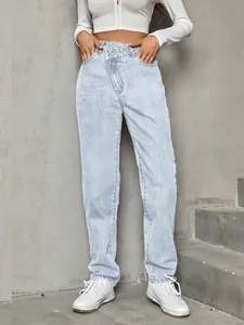 Close-up detail view of light blue high-waisted loose jeans with asymmetrical waistband