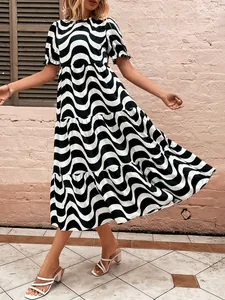 Wavy black and white striped tiered midi dress with puff sleeves in a lifestyle street setting.