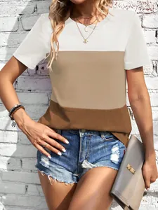 Detail van een casual kleurblok T-shirt in wit en bruin gedragen met een denim korte broek.