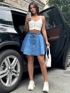Trendy high-waisted denim A-line skirt with front button detail in street style.