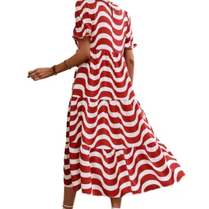 Loose fitting red and white wave print dress with puff sleeves and a tiered skirt design