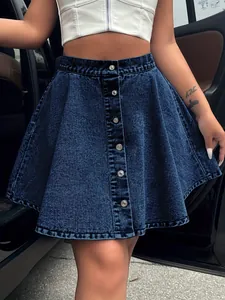 Detail view of high-waisted denim mini skirt with front metal buttons and flared fit