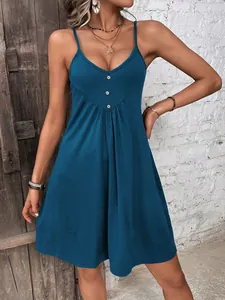 Detailed shot of a casual solid blue camisole mini dress featuring decorative buttons