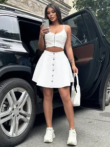 Stylish white high-waisted denim skirt paired with a zip-up crop top in a street setting
