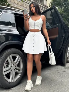 Chic street style photo showing a white high-waisted denim mini skirt with buttons.