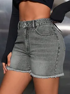Close-up of high-waisted grey denim shorts with raw frayed hem and classic five-pocket design.