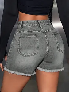 Back view detail of grey high waisted denim shorts with raw hem and straight fit