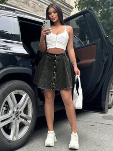 Chic dark wash high-waisted denim skirt with front buttons styled on model outdoors