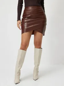 Vue détaillée d'une mini-jupe en cuir PU marron avec ourlet asymétrique drapé