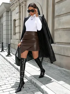Chic brown faux leather A-line mini skirt with asymmetrical wrap design on model