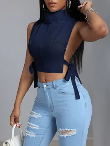 Dettaglio di un sexy top all'americana in denim blu scuro con lacci laterali.