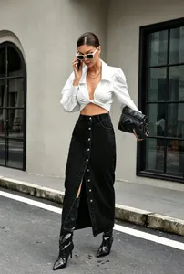 Volledige opname van een retro zwarte denim maxi-rok met knopen voor street fashion