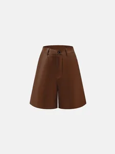 High-quality detailed view of brown faux leather A-line wide leg shorts with button detail