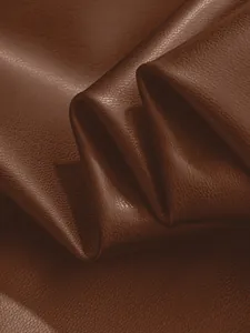 Macro detail shot showing the premium brown PU leather texture and grain pattern
