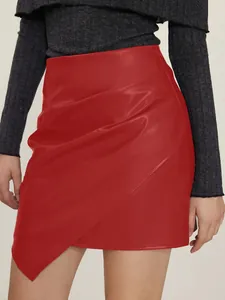 Detail showing the elegant ruched design and smooth texture of this red faux leather mini skirt