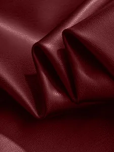 High-quality close-up of wine red PU leather texture with fine lychee grain detail