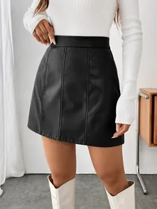 Detail showing the vertical seam design of the black PU leather A-line mini skirt