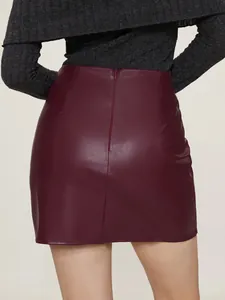 Detailed back view of a burgundy PU leather mini skirt featuring a hidden zipper
