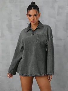 Close-up of oversized grey denim long sleeve shirt with half-zip collar and pocket detail