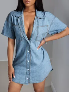 Detail of a light blue denim shirt dress with short sleeves and a turn-down collar.