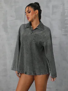 Detail of oversized grey denim long sleeve shirt with half-zip collar and pocket