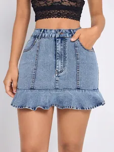 Close-up detail shot of a high waisted light blue denim mini skirt with a stylish ruffle hem