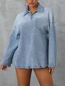 Close-up detail of a loose casual long-sleeved denim top with a front zipper and pocket