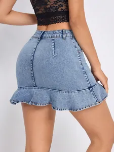 Detail view of a high-waisted blue denim mini skirt with a stylish ruffle hem finish.