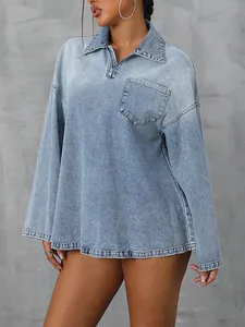 Detail view of a loose casual long-sleeved denim top with half-zip polo collar